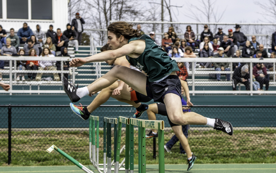 boys jumping hurdles